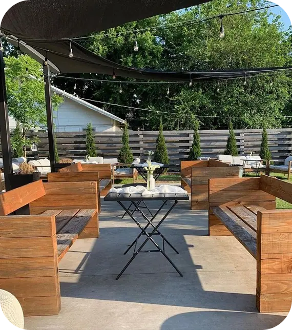 an outdoor seating area with tables and chairs
