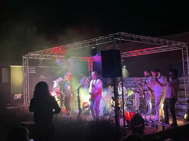 a group of people standing on top of a stage