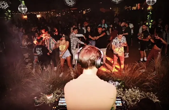 a crowd of people standing around each other
