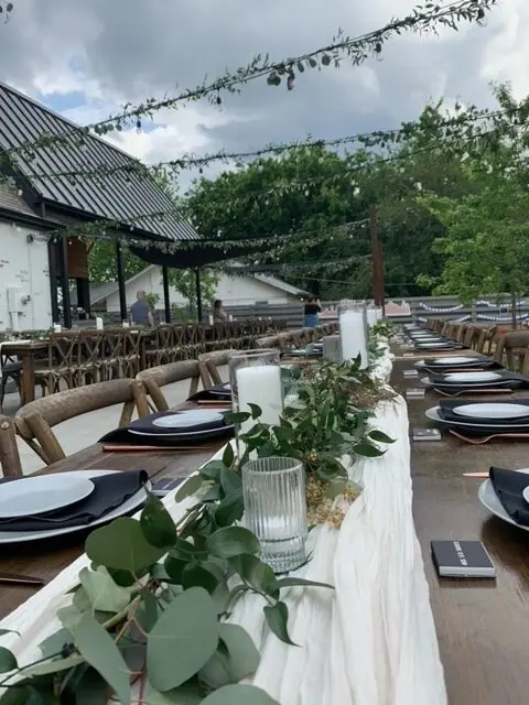a long table set with plates and place settings