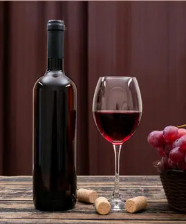 a bottle of wine and a glass of wine on a table