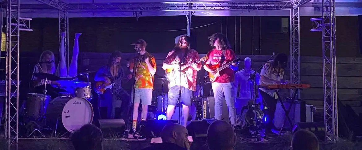 a group of people standing on top of a stage